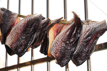 Close-up of dried fish hanging on the balcony to dry