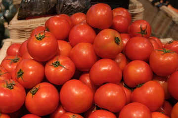 Bright red riped tomatoes on display at a market