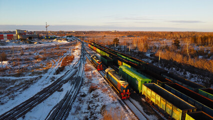 Aerial View of Cargo Trains and Locomotives on Snowy Railway Tracks