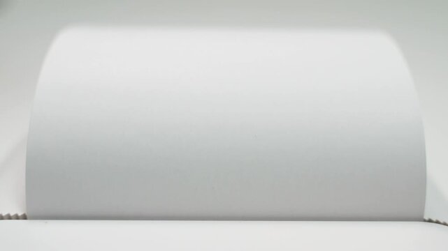 The word FAKE in large black letters printed on white paper, close-up