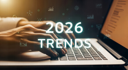 "Hands Typing on Laptop Keyboard with '2026 Trends' on Screen &mdash; Research and Market Analysis"
