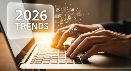 "Hands Typing on Laptop Keyboard with '2026 Trends' on Screen &mdash; Research and Market Analysis"
