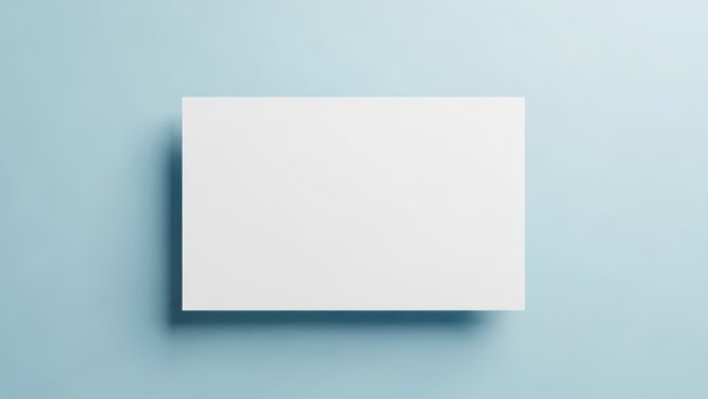 Blank white card casting a shadow on a soft blue background, perfect for mockups.