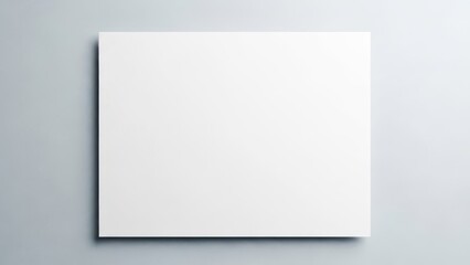 Blank white square paper mockup with a gentle shadow on a clean gray background, providing ample copy space for minimalist design presentations.