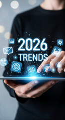 "Business Professional Holding Tablet with Holographic 2026 Trends Data and Technology Icons"
