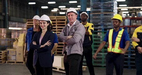 multiracial logistics team posing in slowmotion with crossed arms showing pride and confidence standing together inside warehouse environment symbolizing unity and collaboration - Powered by Adobe