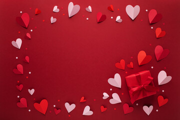 Saint Valentine day background with red and pink hearts and gift box. Festive card for dating and romantic greeting.