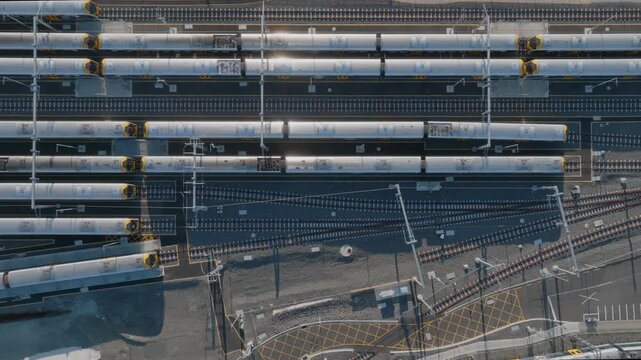 Aerial view of commuter trains parked at a train yard in Auckland, New Zealand. The trains are awaiting their next scheduled run to transport passengers.