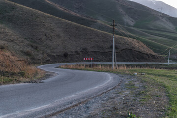 A winding road through the mountains. A concept of life's journey, inviting exploration and adventure in the beauty of nature.