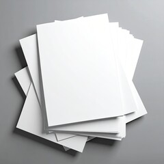 A stack of blank white brochures or magazines on a gray surface