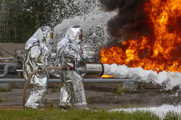Firefighters use a foam generator to supply foam to extinguish the fire. A fire at the plant caused by the ignition of an oil product. Firefighters extinguish a fire at an oil refinery.