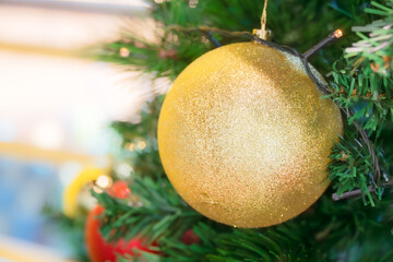 Golden Christmas Ornament on Artificial Christmas Tree