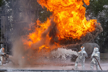 Firefighters use a foam generator to supply foam to extinguish the fire. A fire at the plant caused by the ignition of an oil product. Firefighters extinguish a fire at an oil refinery.