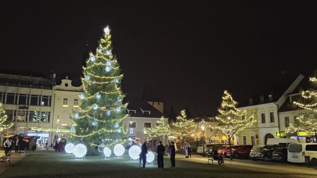 Beroun traditional Christmas market in Beroun town with illuminated kiosques and festive lights on the historic main town square.