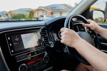 Man driving car traveling down road with map open on the dash