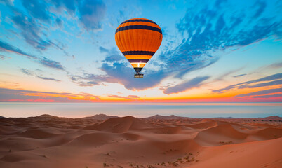 Fototapeta premium Hot air balloon flying over Sahara desert with Atlantic ocean meets - Sahara, Morocco