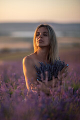 Woman lavender field holding bouquet peaceful blonde standing in fragrant purple sunset nature