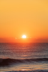 Sunrise Light Behind Low Clouds Over the Ocean