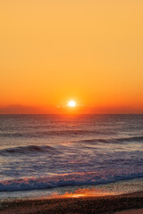 Sunrise Light Behind Low Clouds Over the Ocean