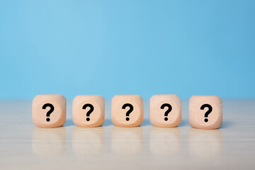Wooden cube block in question mark mean what on wooden table background, column of wooden blocks with question sign mark. copy space,FAQ frequently asked questions, Answer, Information
