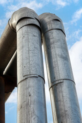 A pipeline above the ground that conducts heat to heat a city. City line in metal insulation in a residential quarter of the city