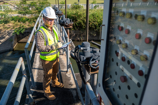Field Engineer Checking Mechanical Systems at Dam and Water Management Facility