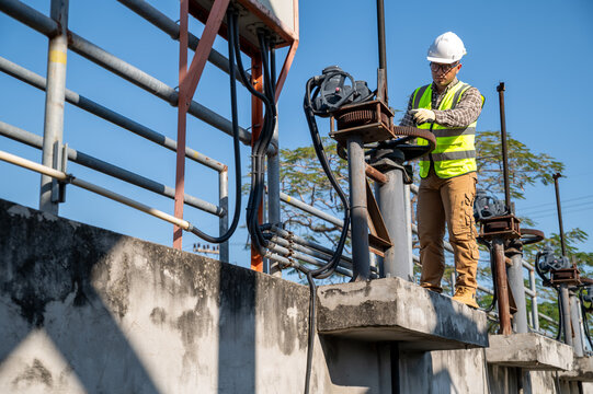 Field Engineer Checking Mechanical Systems at Dam and Water Management Facility