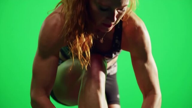 Athlete tying bright neon footwear laces on green screen background