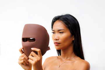 Portrait series of woman interacting with LED facial mask for skincare, beauty tech, and light therapy. Concept of modern wellness and self-care innovation.