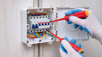 electrician fixing main fuse box 