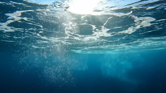 Abstract underwater view looking up at natural light rays creating caustic ripples and flowing patterns on the surface loop, creating, liquid