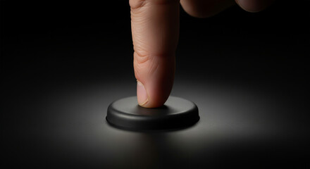 Finger Pressing Button with Dramatic Lighting on Dark Background