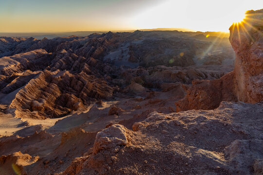 Sunset over bizarre rock formations in Moon Valley Atacama Chile