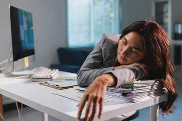 Employee sleeping on desk from overwork and stress