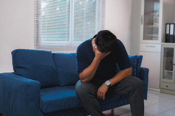 Man experiencing severe depression and emotional stress on sofa