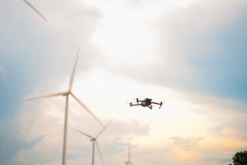 Drone monitoring wind turbines renewable energy site aerial photography outdoor environment upward view sustainability concept