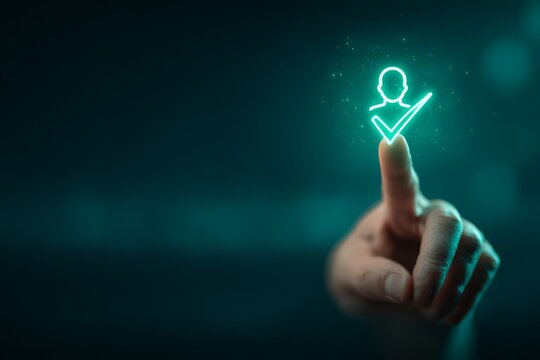 Human finger pressing a glowing human head silhouette with checkmark icon on a digital interface, representing confirmed decision.