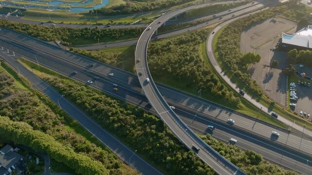 Aerial view of cars driving on a highway interchange in Manukau, Auckland, New Zealand. The scene shows the infrastructure and transportation system.