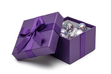 Opened purple gift box filled with shiny Christmas baubles on white background