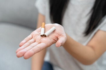 Quit smoke, No smoking health care concept, addiction asian young woman, girl refuse cigarette, smoker quitting smoke, hand in broken, holding break tobacco. Quit bad habit campaign, cancer disease.