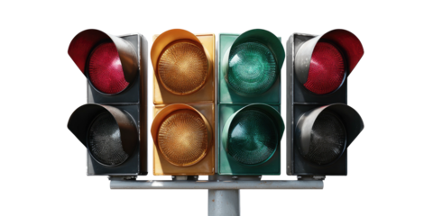 A close-up view of a four-sided traffic signal, with red, yellow, and green lights illuminated