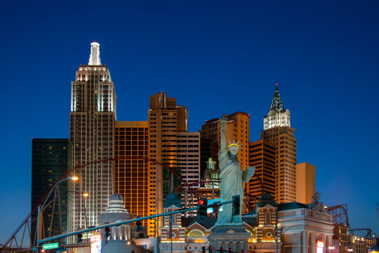 the casino and hotel New York New York with statue of Liberty and empire state building at the strip in Las Vegas by night