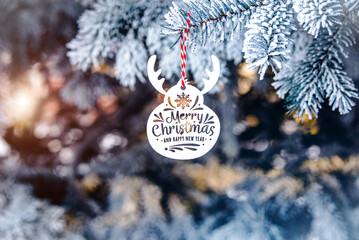 Congratulations on Christmas and New Year on snow-covered fir trees
