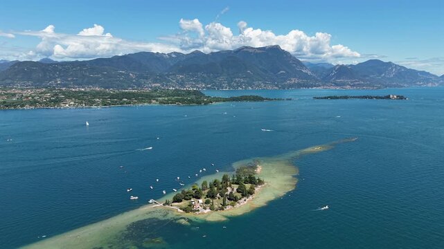 Cinematic 4K drone video of Isola di San Biagio, Lake Garda, Italy, showing peaceful island and landscape.