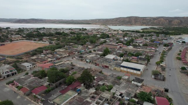 Aerial Pan Shot Over Araya Town, Venezuela: Coastal Village and Lake