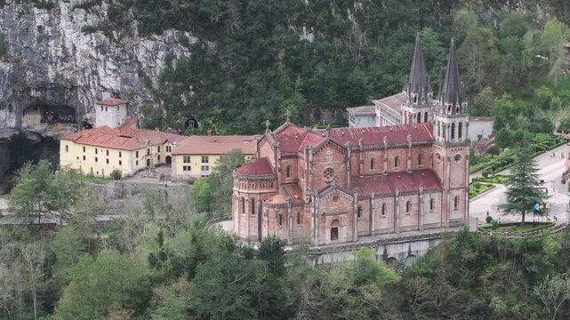 Slow modern and clear aerial drone shot of Covadonga Basilica, church in the Cantabrian mountains in Northern Spain, Europe