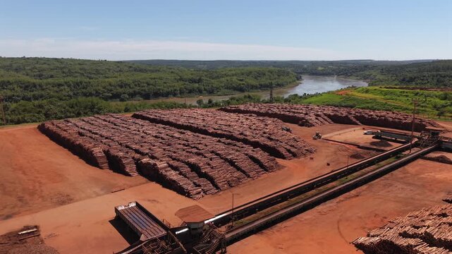 Wide panorama aerial view of massive and arranged pine logs at wood factory facility.