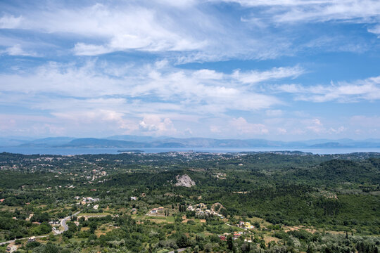 Panoramic view from Kaiser's Observatory in Pelekas, Corfu Greece. Green hills, small villages and distant sea, blue sky