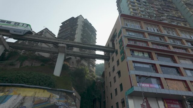Famous Liziba station monorail train entering a high-rise building in Chongqing city, China