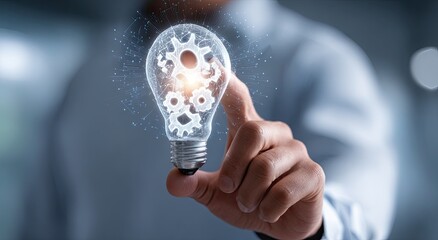 Person's finger touches glowing light bulb with spinning gears inside, symbolizing innovation